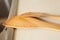 Two wooden trowels and coarse salt grains on a white board close to the  kitchen sink