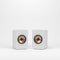 Two wooden white speakers with golden speaker driver