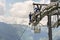 Two workers doing maintenance on cable car with Alps mountains in backgroun, Schonleitenbahn on Wildenkarkogel, Austria