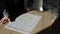 Two workers are examining a plan of production on a factory, viewing a paper with graphics, lying on a table