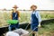 Two workers on the farmland outdoors