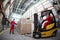 Two workers loading pallets with forklift truck