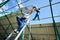 Two workers mounting solar batteries on metallic construction.