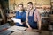 Two Workers Posing in Woodworking Shop