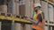 Two workers in a warehouse are discussing work. Engineers in a factory warehouse