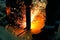 Two workers weld metal part in a workshop at the workplace. Bright welding sparks