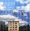 Two working climbers on a glass wall of a high-rise building