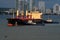 Two working tugboats moving an unloaded container ship