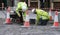 Two workman repairing pavement