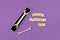 Two wrenches in gift box and text Happy Fathers Day on purple background