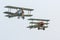 Two WW I aircraft, a Sopwith Camel and a Fokker Triplane, in the air