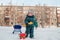 Two year old boy in the winter suit dripping snow