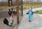 Two-year-old girl looks at a cock in a volver on the territory of a bird house