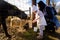 Two year old girl mother in farmland feeding farm animals