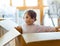 Two-year-old girl plays in a cardboard box during the move