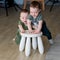 The two year-old twin brothers play a small chair.