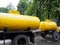 Two yellow barrels of the tank on wheels