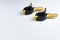 Two yellow building clamps lie on a white background. close-up. Place for sign