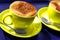 Two yellow coffee cups