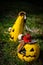 Two yellow Jack-O-Lantern on grass