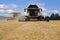 Two Yellow New Holland Combines on Field