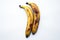 Two yellow over ripe bananas with bwown spots