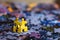 Two yellow puzzles are walking together after scattered puzzles with blurry background
