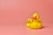 Two yellow rubber ducks toys, copy space. Cute funny bath toys, minimal kidult concept. Pink background