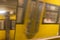 Two yellow subways pass the subway station