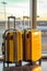 Two yellow suitcases sitting next to each other. Generative AI image.