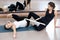 Two yogi female practicing yoga therapy in class