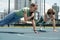 Two young active female athletes doing difficult physical exercise