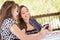 Two Young Adult Girlfriends Using Their Smart Cell Phone