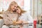 Two young affectionate female shopaholics in smart casual sitting in cafe