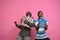 two young african men holding presents feeling excited and happy, celebrating