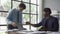 Two young asian businessmen in suits discussing financial market data in office Business team working