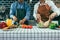 Two young asian couples are helping each other and enjoying cooking in the kitchen