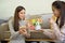 Two young Asian female e-commerce entrepreneurs checking their goods before packing