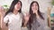 Two young asian woman sing karaoke at home