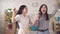 Two young asian woman sing karaoke at home slow mo