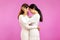 Two Young asian women posing in concept of lgbtq Lesbian couple  on pink background