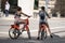 Two young attractive females on bikes