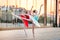 Two young ballerinas in a bright red and blue tutu are dancing against backdrop of the reflection of city sunset