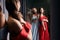 Two young beautiful girls wearing off-the-shoulder full-length sky blue and crimson red satin slit prom ball gowns