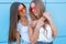 Two young beautiful smiling hipster girls in trendy summer colorful neon sunglasses. carefree women posing near