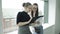 Two Young beautiful women discuss different documents near windows