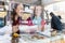 Two young and beautiful women enjoying cakes and coffee in a trendy cafe