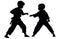 Two young boys doing karate silhouette, Two karate young boys fighters in a match