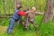 Two young boys fighting over a rustic old gate