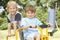 Two Young Boys Playing on Bike